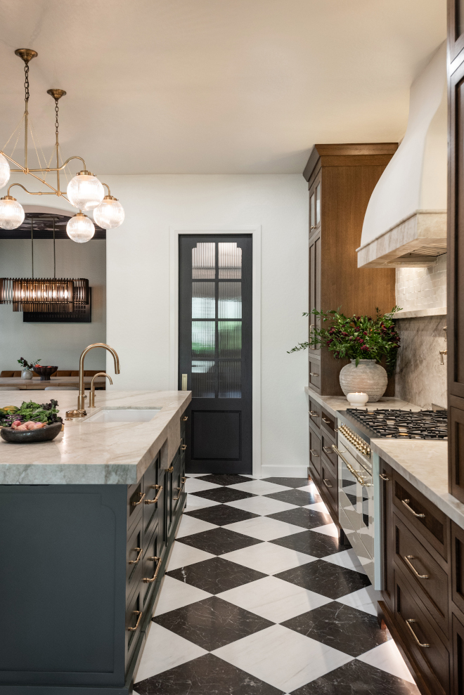iron-ore-pantry-door-sherwin-williams Pantry door painted Sherwin-Williams Iron Ore with ribbed glass inserts in a luxury kitchen.