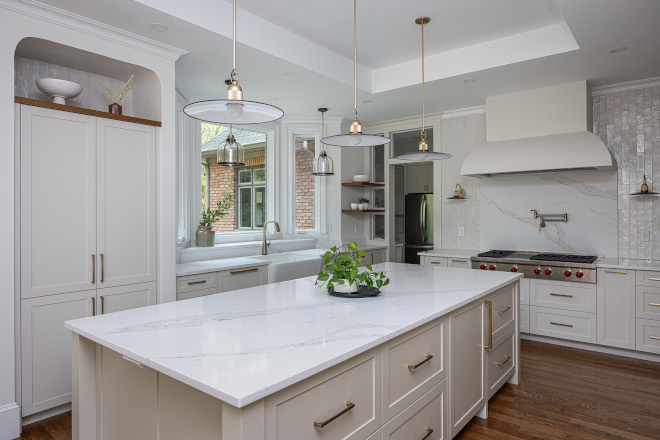 Large Warm Taupe Kitchen Island in Sherwin Williams Slumber Sloth with Custom Cabinetry and Brass Pendant Lights