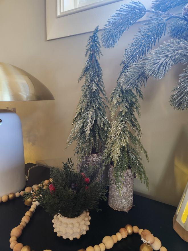 frosted faux pine needle trees feature a slender downswept branch with rustic birch-style base