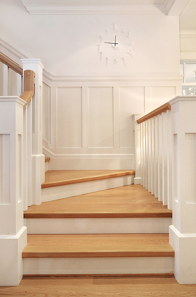 Staicase leading to upper level with built-in bookcase. Floors are white oak. Sunshine Coast Home Design.