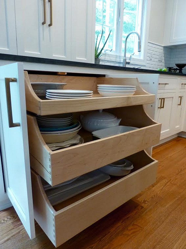 Kitchen Pull-out Drawers. Kitchen with pull ot drawers. Here, the designer explains more about the kitchen pull out drawers: "Underneath you can open up the two doors to reveal three large pull out drawers that house my large serving dishes. No more being on your hands and knees trying to pull them out from the bottom of the cabinets, I literally can open the drawers up and see what I need. The sides of the pullouts are staggered so you can see in easily too. The countertop cabinet doors fold back onto themselves to tuck out of the way so when open you don't bump into them. I was very inspired by English kitchens and wanted to incorporate this." Kate Abt Design. #Kitchen #KitchenPullOutDrawers #PullOutDrawers