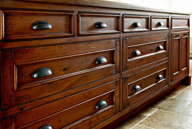 Kitchen Island. Distressed Kitchen Island. Distressed Kitchen Island Design. Heavy physical distressing was inflicted to the cherrywood on the island to help impart the appearance of age. Weathered bronze cups and knobs complete the look. #Kitchen #KitchenIsland #DistressedKitchenIsland #DistressedIsland Heidi Piron Design.