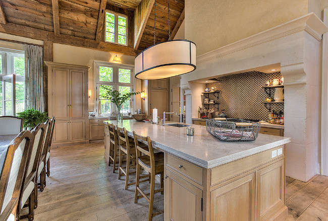 French Country Kitchen. French Country Kitchen with Limestone Kitchen Hood, large kitchen island. This French Country Kitchen features reclaimed barn wood ceiling and plank hardwood floors. #FrenchCountry #Kitchen