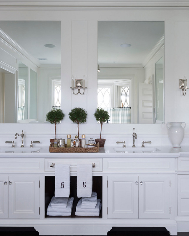 Bathroom Cabinet Design Ideas. Master Bathroom Cabinet. This double vanity includes both concealed and display storage spaces. Its mirrors reflect the view at the bay window behind. #Bathroom #MasterBathroom #BathroomCabinet 