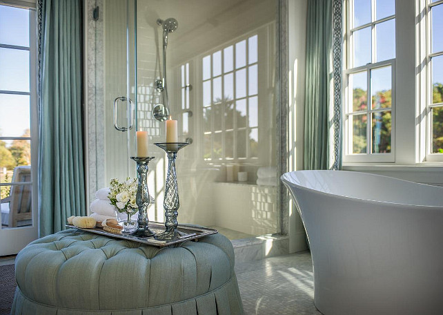 Bathroom Ideas. A plush tufted ottoman holds romantic accessories and adds a feminine touch to this incredible master bathroom. #Bathroom #BathroomIdeas