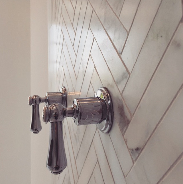 Bathroom Shower Faucet by Perrin and Rowe. This is the perfect match with the white calacata herringbone wall. Graystone Custom Builders