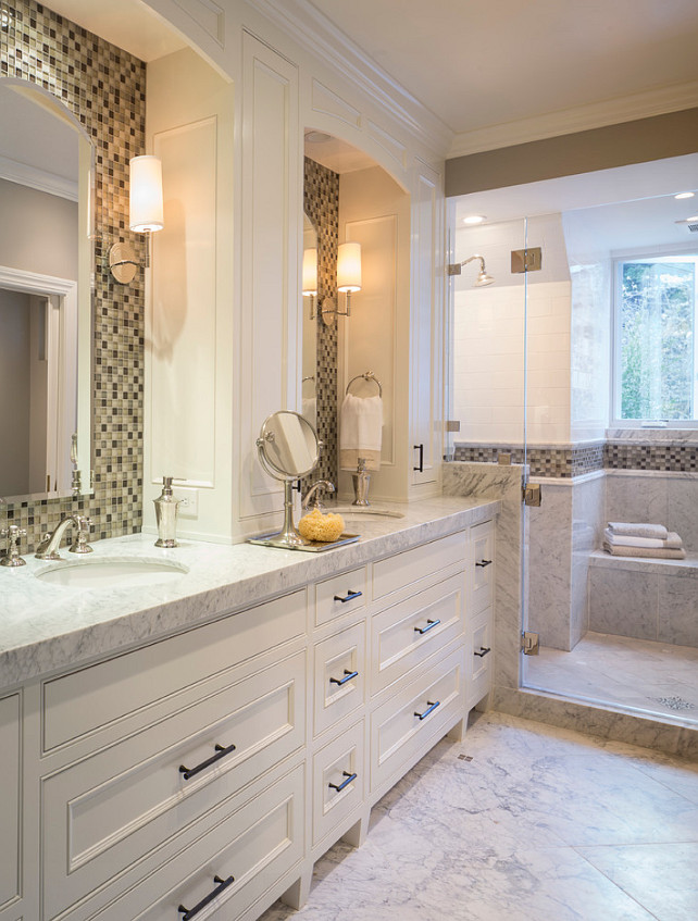 Bathroom Tiling Ideas. Master bathroom with custom double vanity. Glass mosaic tile in a neutral blend. Honed Cararra floor with random dot tile inserts. #Bathroom #Tiling #BathroomTiling Brownhouse Design.