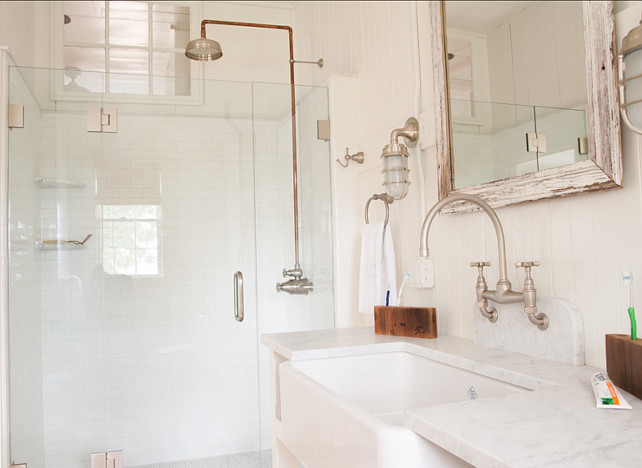 Bathroom. Coastal Bathroom Design Ideas. The vanity was custom made and the sink used was a porcelain farmhouse sink. The lights are from Urban Archaeology. #Bathroom #CoastalInteriors