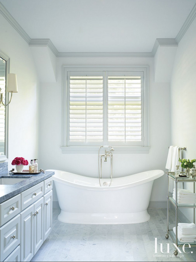 Bathroom. The elegant master bathroom includes Carrara marble tile flooring from Materials Marketing and countertops from Walker Zanger. #Bathroom Courtney Hill Fertitta.