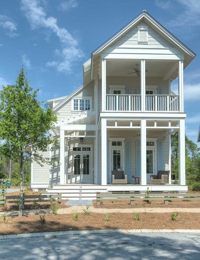 Beach House Design. Beach house with front porch and turquoise blue shutters. #BeachHouse #Shutters #Turquoise Christ & Associates.