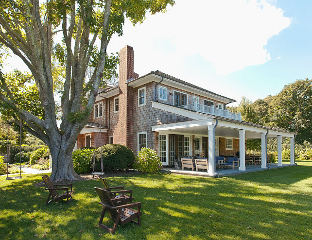 Beach House. Shingle beach house backyard with swing, mature landscaping, back porch and dream architecture. Via Sotheby's Homes.