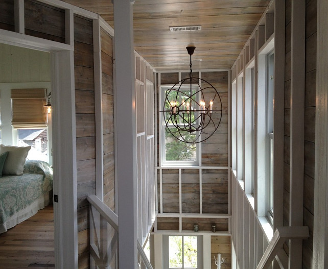 Beach house with the Foucault's Orb 32" chandelier from Restoration Hardware, large wood panel walls and exposed white planks painted in whitewash. #BeachHouse #PlankWalls