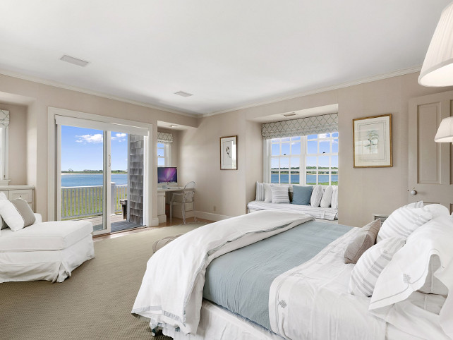 Bedroom. Neutral Bedroom. Neutral beach house with beige walls, white and blue bedding and window seat with white cushion and pillows. #Bedroom