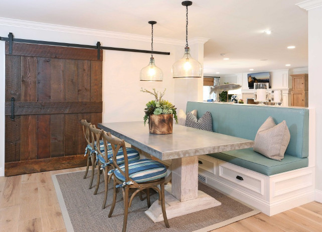 Breakfast Nook. Breakfast Nook with banquette, chairs and zinc top table. A barn door made of reclaimed wood conceals the kitchen pantry. #BreakfastNook Blackband Design.