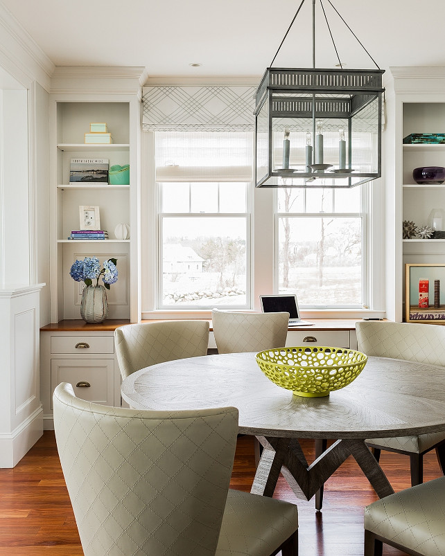 Breakfast Nook. Kitchen Breakfast Nook Ideas. Transitional breakfast nook with square gray lantern pendant and cabinets framing window. #BreakfastNook #Kitchen Jennifer Palumbo.