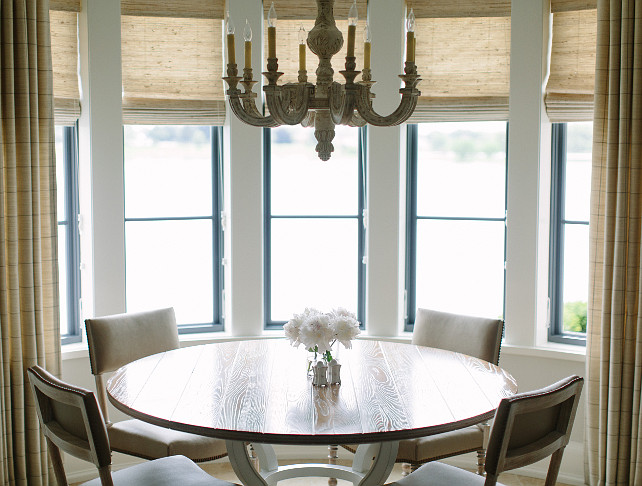 Breakfast Room with shades and curtains. Breakfast Room with bay windows covered with shades and curtains. Kate Marker Interiors.