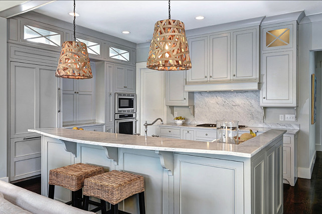 Casual Gray Kitchen. Gray Kitchen Paint Color. Causal Gray Kitchen Design. The kitchen island features a pair of "Serena and Lily Birds Nest Hanging Lamps". #GrayKitchen #Kitchen