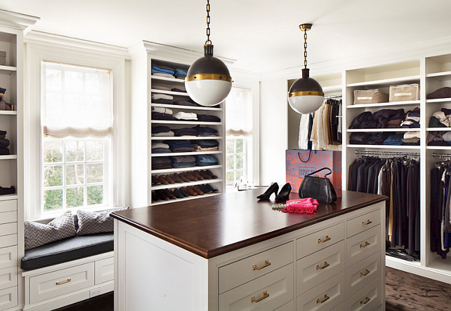 Closet. Closet Cabinet Ideas. #Closet. Lighting pendants are the Hicks Pendants by Circa Lighting. This dreamy walk-in closet boasts "Small Hicks Pendants" illuminating wood topped closet island with drawers. Custom floor to ceiling built-ins store clothes and shoes flanked by built-in window seats. Don't we all deserve a closet like that? Alisberg Parker Architects.
