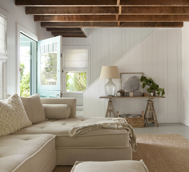 Cottage Living Room Design. Neutral Cottage Living Room. Cottage living room features rustic plank ceiling and white plank walls. #Cottage #BeachCottage #Livingroom.