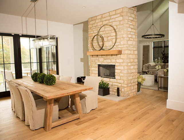 Dining Room Fireplace. Stone Dining Room Fireplace. Bleached hardwood flooring and stone fireplace in transitional dining room. #DiningRoom #Fireplace Hahn Builders.