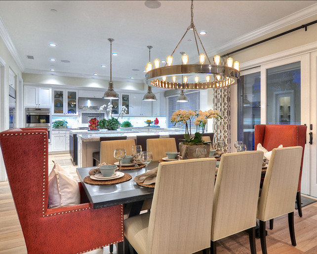 Dining Room Ideas. Eight upholstered chairs, including two terracotta colored arm chairs, surround this large dining table. #DiningRoom #DiningRoomFurniture #DiningRoomIdeas #DiningRoomDecor