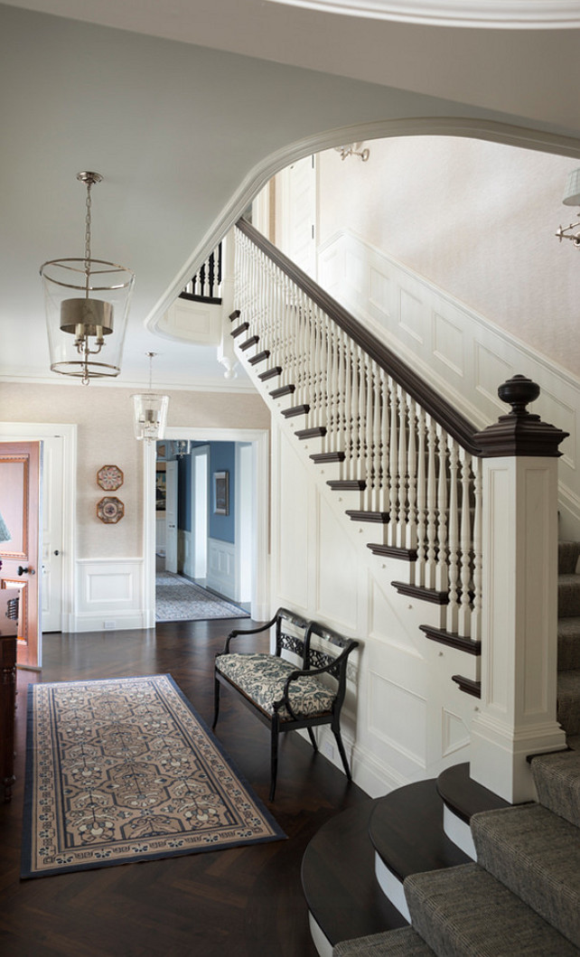 Entryway Design - Traditional Entryway Design. Traditional entryway with herringbone hardwood flooring and classic banister design. The lanterns is by Vaughan. #Entryway #EntrywayLighting #EntrywayBanister #HerringboneFlooring 