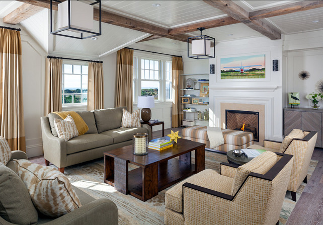 Family Room. Transitional Family Room Design with subtle coastal decor. Reclaimed wooden beams are repeated in the family room. Also notice the ocean views and the transitional decor. Light fixture is from Hudson Valley Lighting. Paint Color is 50% China White, 50% Linen White by Benjamin Moore. #FamilyRoom #CoastalInteriors