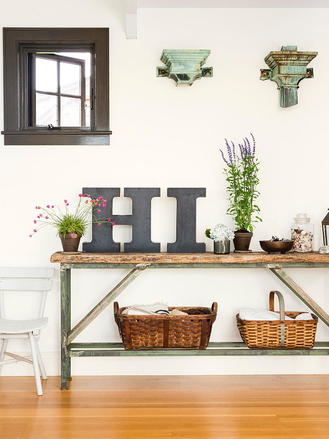 Foyer Decor. Foyer with narrow weathered wood table with a metal base. #Foyer #FoyerDecor HGTV.