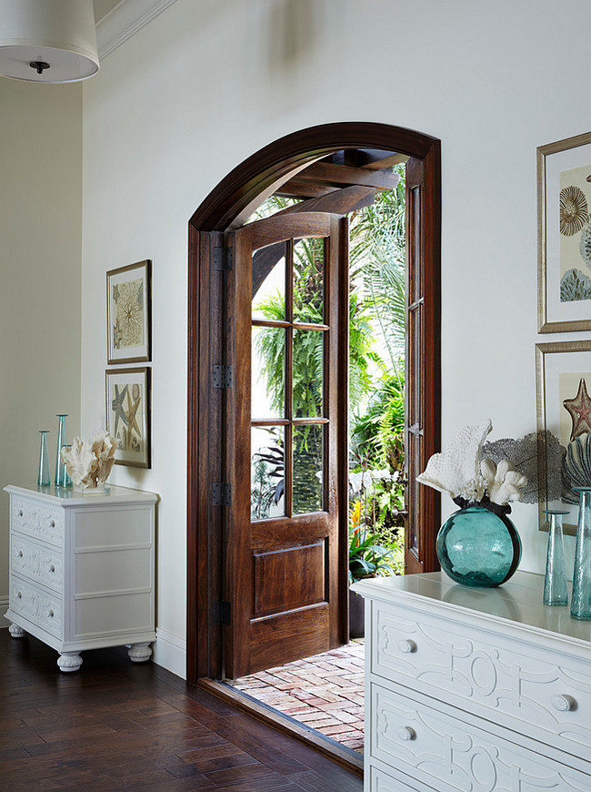 Foyer. Coastal Foyer ideas. Coastal foyer with double dressers and turquoise decor. In the foyer, artworks from Wendover Art Group float above Century Furniture chests from Designers Buying Group. #Foyer #CoastalInteriors #Turquoise #decor JMA Interior Design.