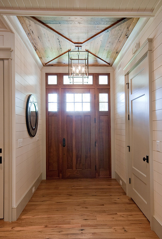 Foyer. Foyer with custom door, wood ceiling and tongue and groove walls.