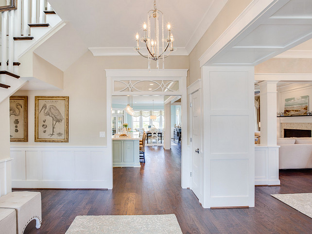 Foyer. Neutral Foyer Paint Color. This neutral foyer carries a coastal feel. Sand paint color is Sandbar by Sherwin Williams. Chandelier is the Nissé chandelier by Progress Lighting.