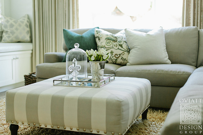 Gray stripe ottoman coffee table. Living room with gray stripe ottoman coffee table. #graystripe #ottoman #coffeetable Oviatt Design Group.