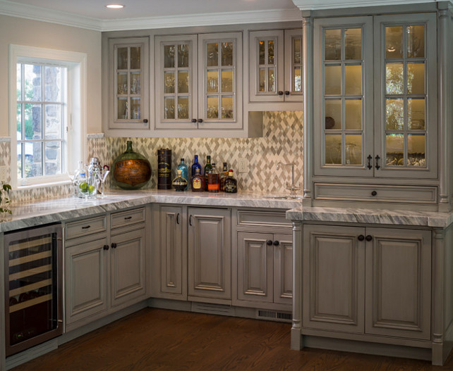 Kitchen Bar. Kitchen bar across from the kitchen, in the family room. Rhomboid mosaic blend of stone and crackled glass. Mini wine fridge and prep sink. #KitchenBar #Kitchen #Bar Brownhouse Design.