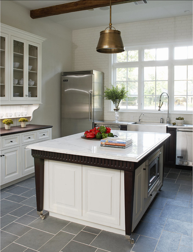 Extendable Kitchen Island. Beautiful kitchen design ideas! This kitchen has crisp white cabinets and an extendable kitchen island design. Pendants are the “Single Sloane Street Shop Light With Metal Shade” in antique brass. #Kitchen. #KitchenIsland #KitchenDesign