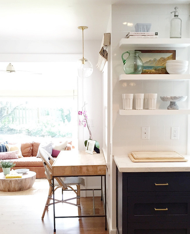 Kitchen Desk Ideas. Two-toned kitchen opens to a small area filled with a desk. Shea McGee Design.