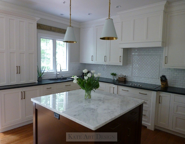 Kitchen Ideas. Kitchen Makeover Ideas. Kitchen Design Ideas. Kitchen. Kitchen - custom cabinetry by Woodburn Cabinets in Ben Moore OC17 White Dove and island in cherry wood. Countertops - perimeter is leathered black granite, island countertop is Mont Blanc marble Backsplash is Thasos marble 2x4 beveled and above cooktop is Thasos marble in an arabesque design. Hardware for kitchen and Butlers is by Atlas hardware Walls are Ben Moore Winds Breath OC24 Island Pendants are the Goodman Pendants by Visual Comfort Floors - oak #kitchen #Kitchenreno #KitchenMakeoverKate Abt Design.