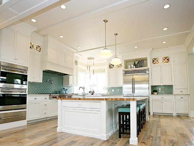 Kitchen Ideas. White Kitchen with Turquoise Decor. The custom designed white kitchen island has maple butcher block countertops and espresso stained counter stools with blue vinyl tufted cushion. #WhiteKitchen #turquoise #Kitchen