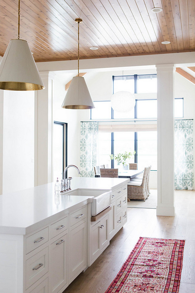 Kitchen Island with Farmhouse Sink. White kitchen island with white quartz countertop and farmhouse sink. #KitchenIsland #FamrhouseSink Ashley Winn Design.