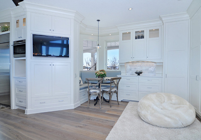 Kitchen Nook. Small kitchen nook with custom cabinets, desk, hardwood floor. Great comfy area with rug and pouf. Martin's Custom Finishing Ltd .