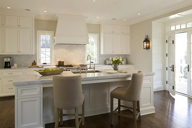 Kitchen Stools. White kitchen island with sleek marble counterop and Restoration Hardware 1940s French Upholstered Barrelback Counter Stools. #KitchenStools Anne Decker Architects.