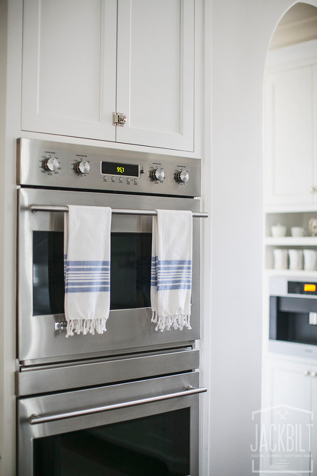 Kitchen Wall Oven Cabinet. Kitchen features stainless steel double wall ovens stacked between white shaker cabinets. Double ovens. Wall ovens. Double wall ovens JackBilt Homes.