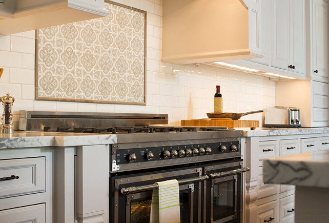 Kitchen with black Bertazonni Range. Backsplash over the range is American Tile and is called Spanish Cathedral. Backsplash is subway tile is by Daltile and is called Snowdrift. Whitestone Builders.