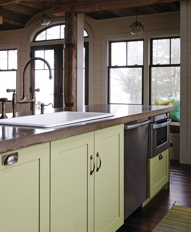 Kitchen with concrete Countertop. The kitchen faucet is the Perrin & Rowe. It is in an English Bronze finish. Cabinet paint color is Valspar La Fonda Olive. #ConcreteCountertop #Kitchen OLSON LEWIS + Architects.