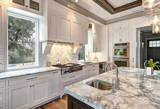 Kitchen. Countertop bar sink, Kitchen beamed ceiling, glass pendant lights, gray countertop, prep sink, recessed lighting, rustic wood ceiling beams, wall ovens. Ink Architecture.