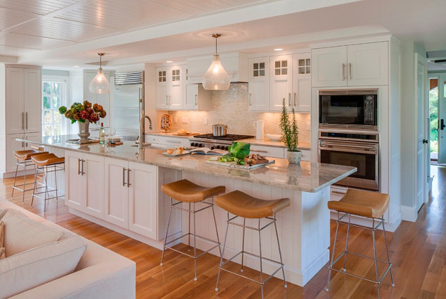 Kitchen. Kitchen with white cabinets, large kitchen island, barstools, glass pendants over island and beadboard ceiling. #Kitchen #KitchenIdeas #WhiteKitchen  #KitchenCabinet  Polhemus Savery DaSilva.