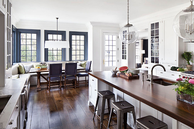 Kitchen. Open Kitchen design with custom white cabinets and custom banquette in breakast room. Pendants are the "Sorenson 18 Lantern by Remains Lighting". #Kitchen #Banquette #Customkitchencabinet #CustomKitchen Alisberg Parker Architects.