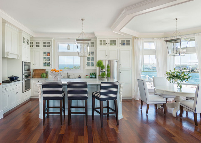 Kitchen. White kitchen with blue kitchen island. The striped counter stools add a coastal flair to this kitchen. #Kitchen #CoastalKitchen #KitchenIsland . Kate Jackson Design.