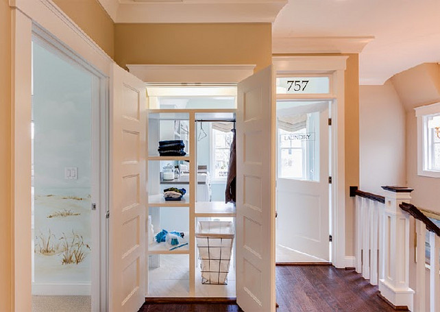 Laundry Room. Pass-through shelving accessible both from inside the laundry room and from just outside provides “get it yourself” convenience. This is such a smart idea! I would love to incorporate it at home. I might would want to make each shelf wider to place laundry baskets. Every family member would have their own shelf. Laundry Room Ideas. #laundryRoom #laundryRoomIdeas