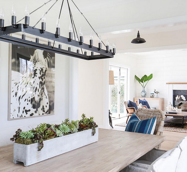 Linear Chandelier Dining Room. Dining room with Linear Chandelier, black and white horse picture and white walls. #DiningRoom #LinearChandelier . Blackband Design.