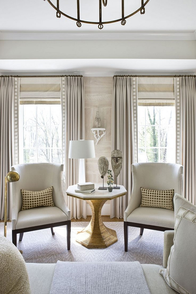 Living Room Draperies and Roman Shades. Living room with horizontal stripe roman shade - roman shade mounted at height of rod. #LivingRoom #Draperies #RomanShades #WindowTreatment Via Michael Hampton Design.